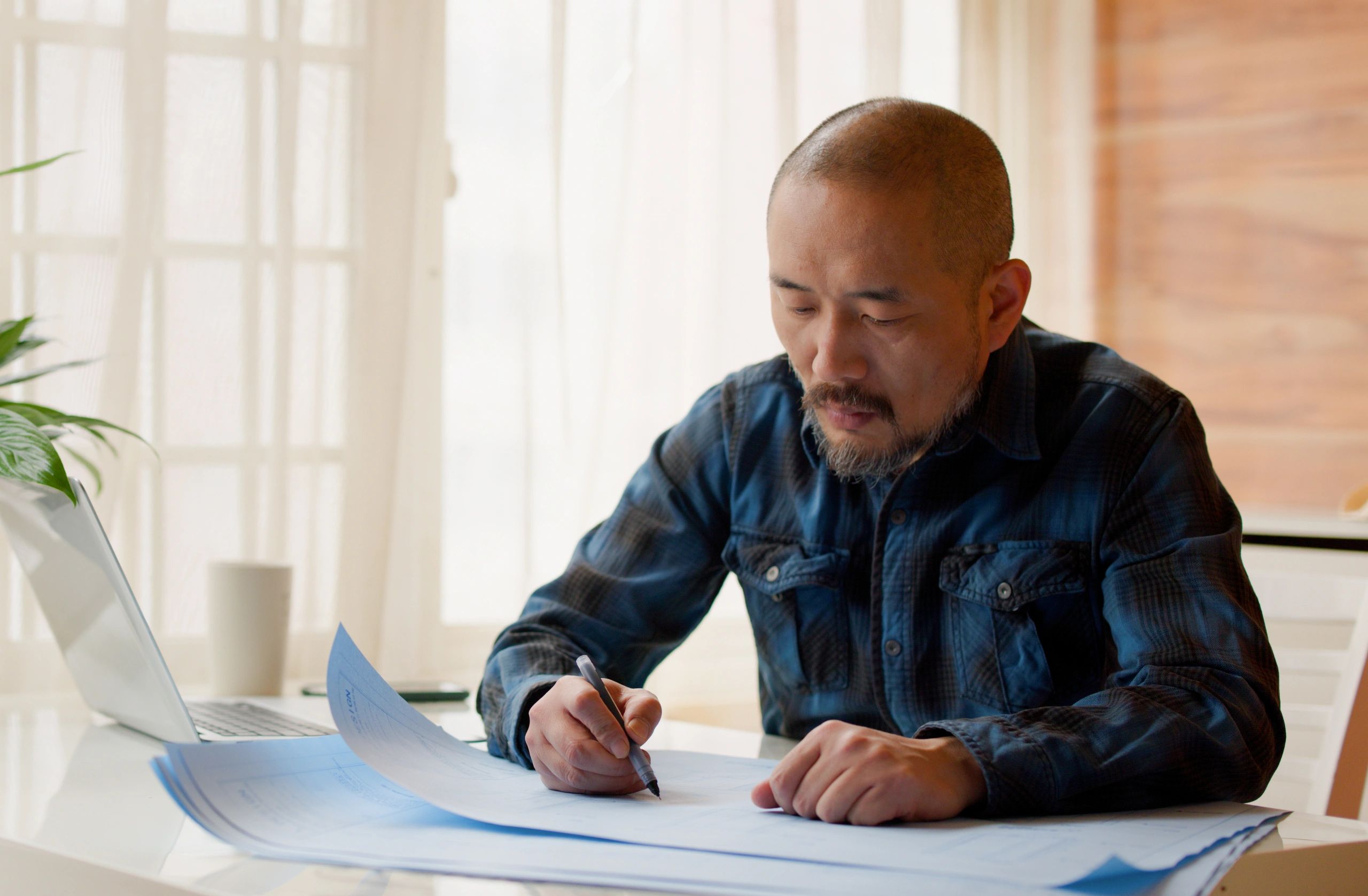 Designer revising drawings on a laptop