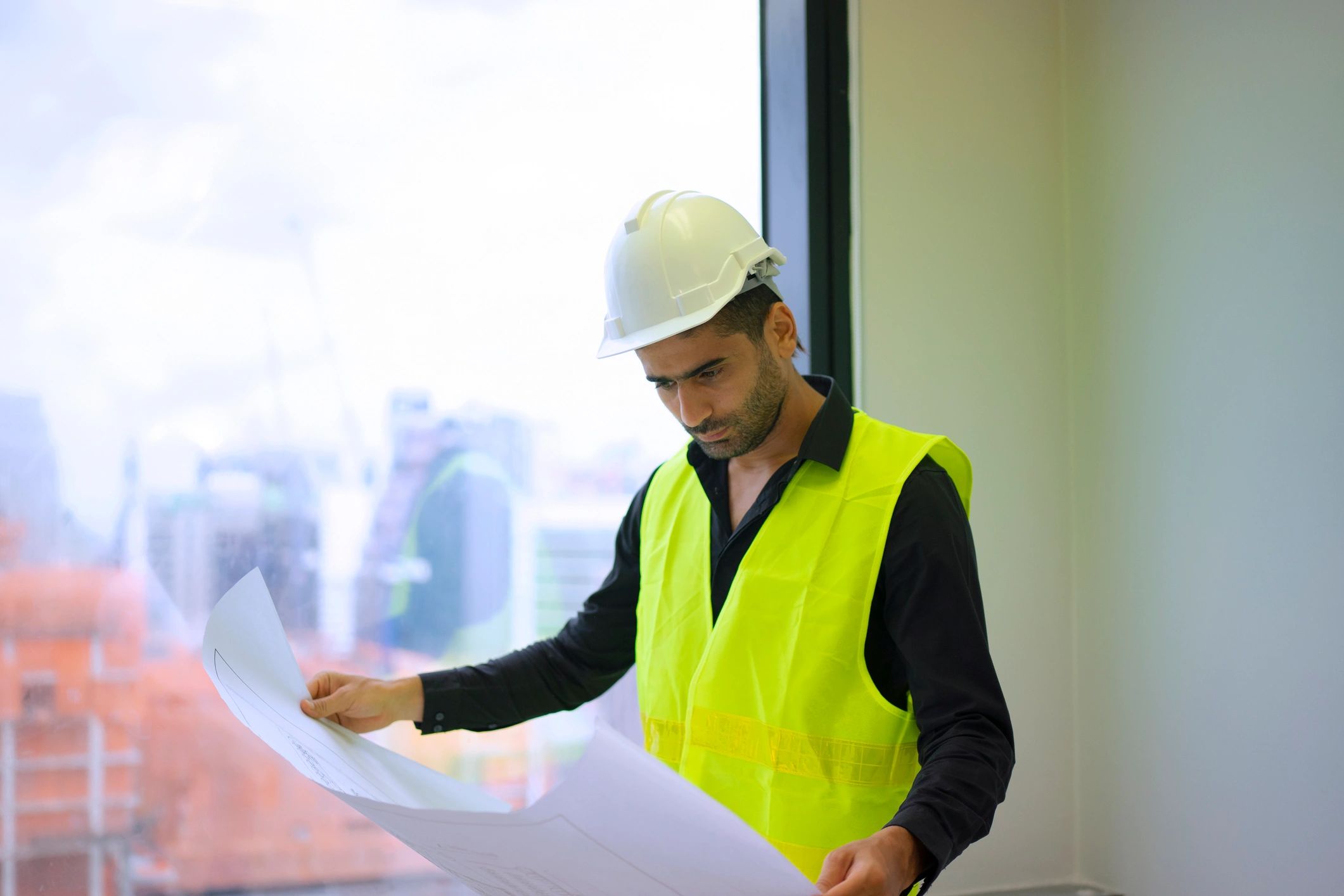 Engineer reviewing construction documents on site