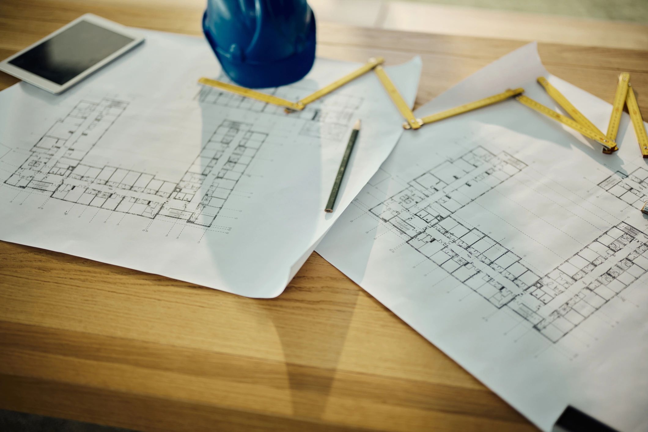 Blueprints and drafting tools on a desk