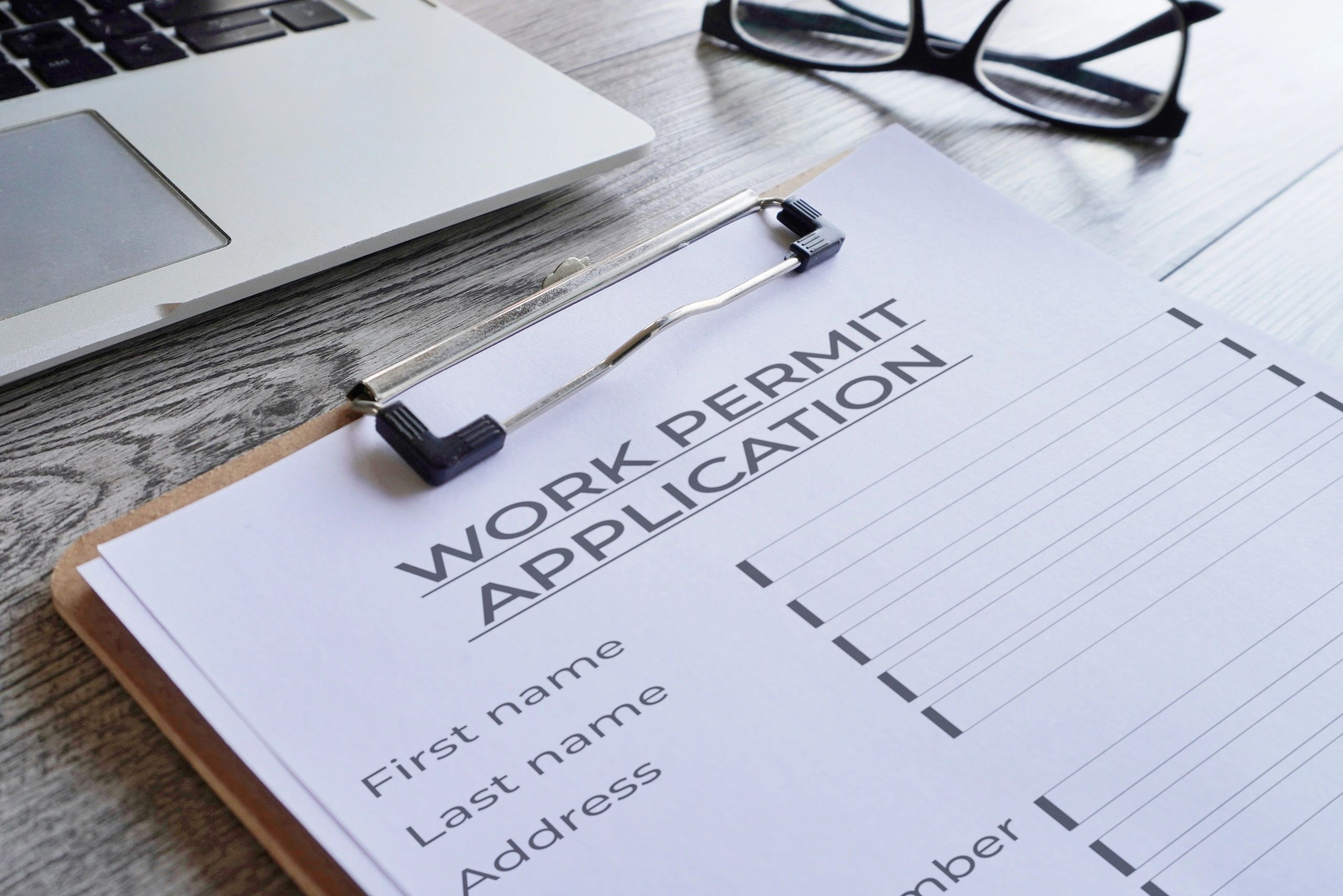 Permit application form on a clipboard.