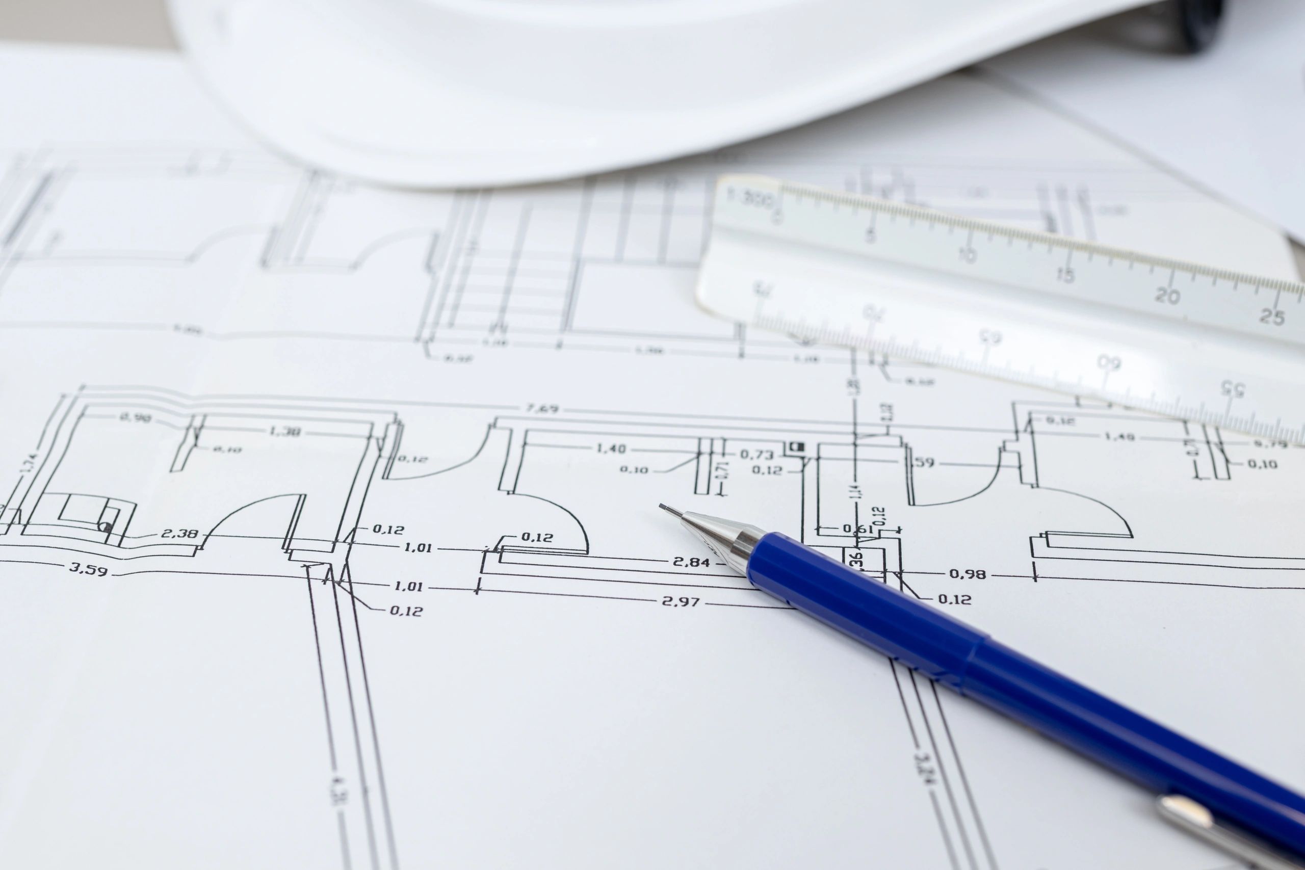 Close-up of residential blueprints with a pen.